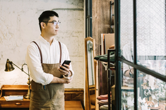 Owner of small business looks out window