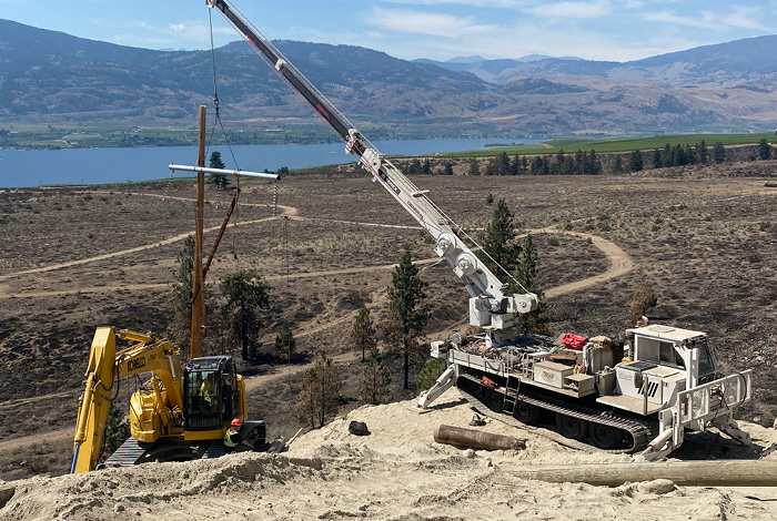 Commercial equipment repairing electricity structures due to the Nk’Mip Creek wildfire