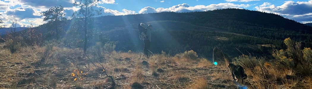 Jeremy Dresner hiking with child on back