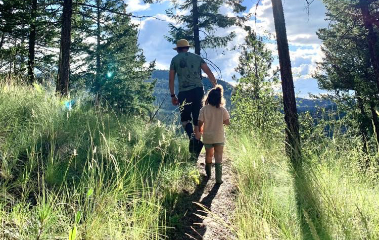 Jeremy Dresner hiking with child in sunshine