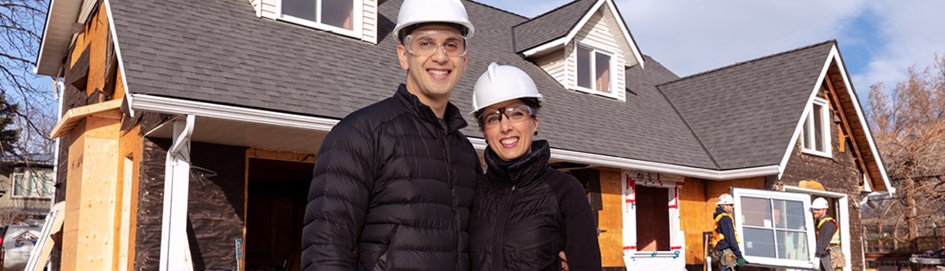 Shane and Colleen wearing PPE standing in front of their home