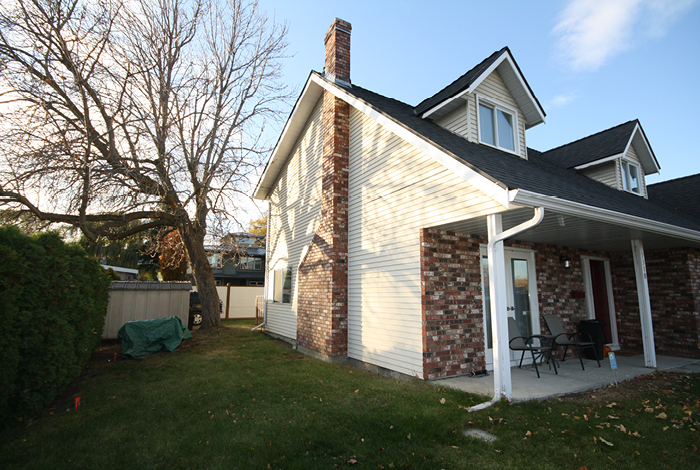 Before photo of the house left exterior, chestnut tree blocking window