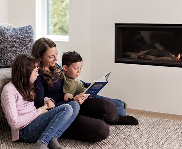 Colleen reading a book to the kids near the EnerChoice high-efficiency natural gas fireplace
