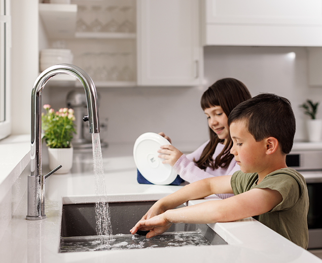 The kids doing dishes in the kitchen