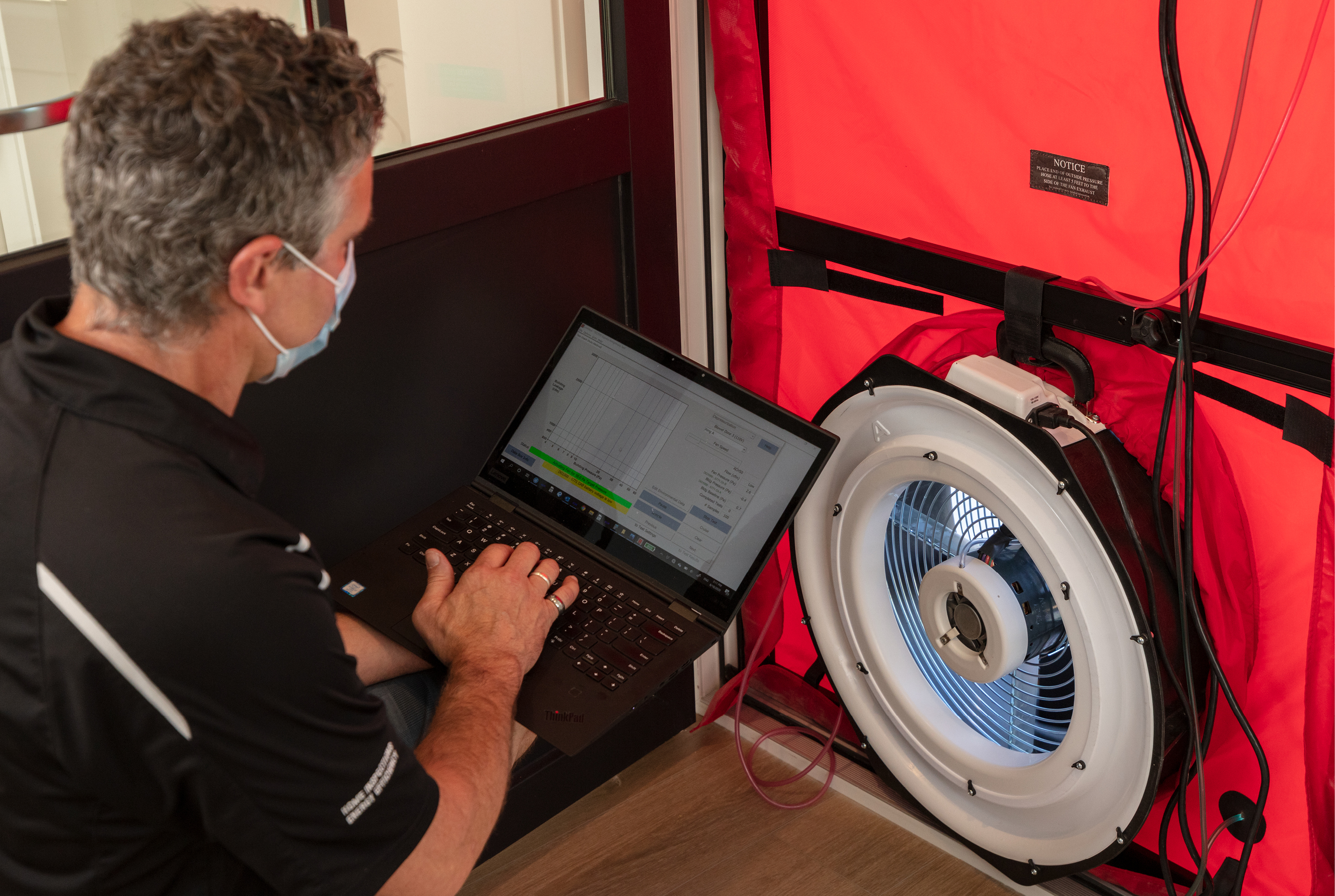 A blower door test being performed on Colleen and Shane’s home to determine the amount and areas of heat loss.