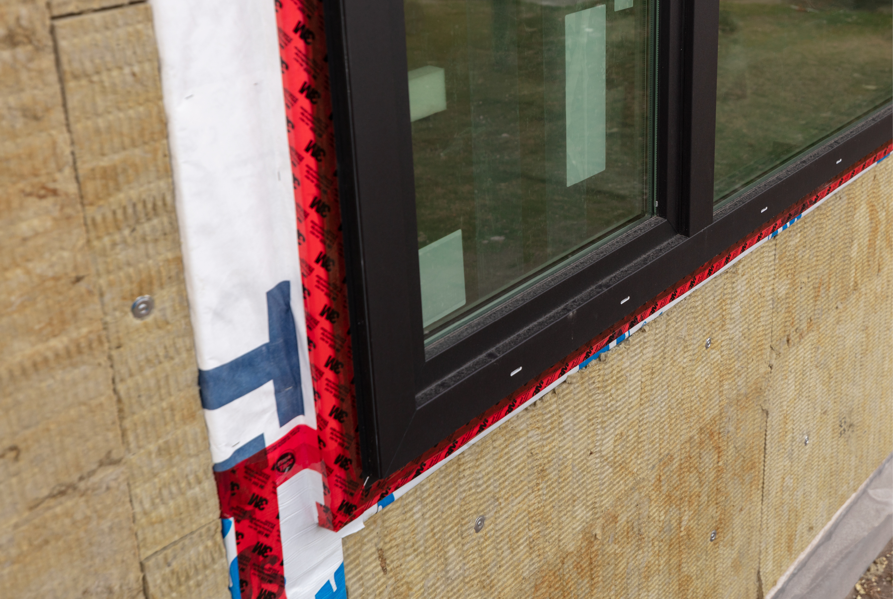 Insulation cladding on the exterior and high-efficiency windows are two components of a good building envelope.