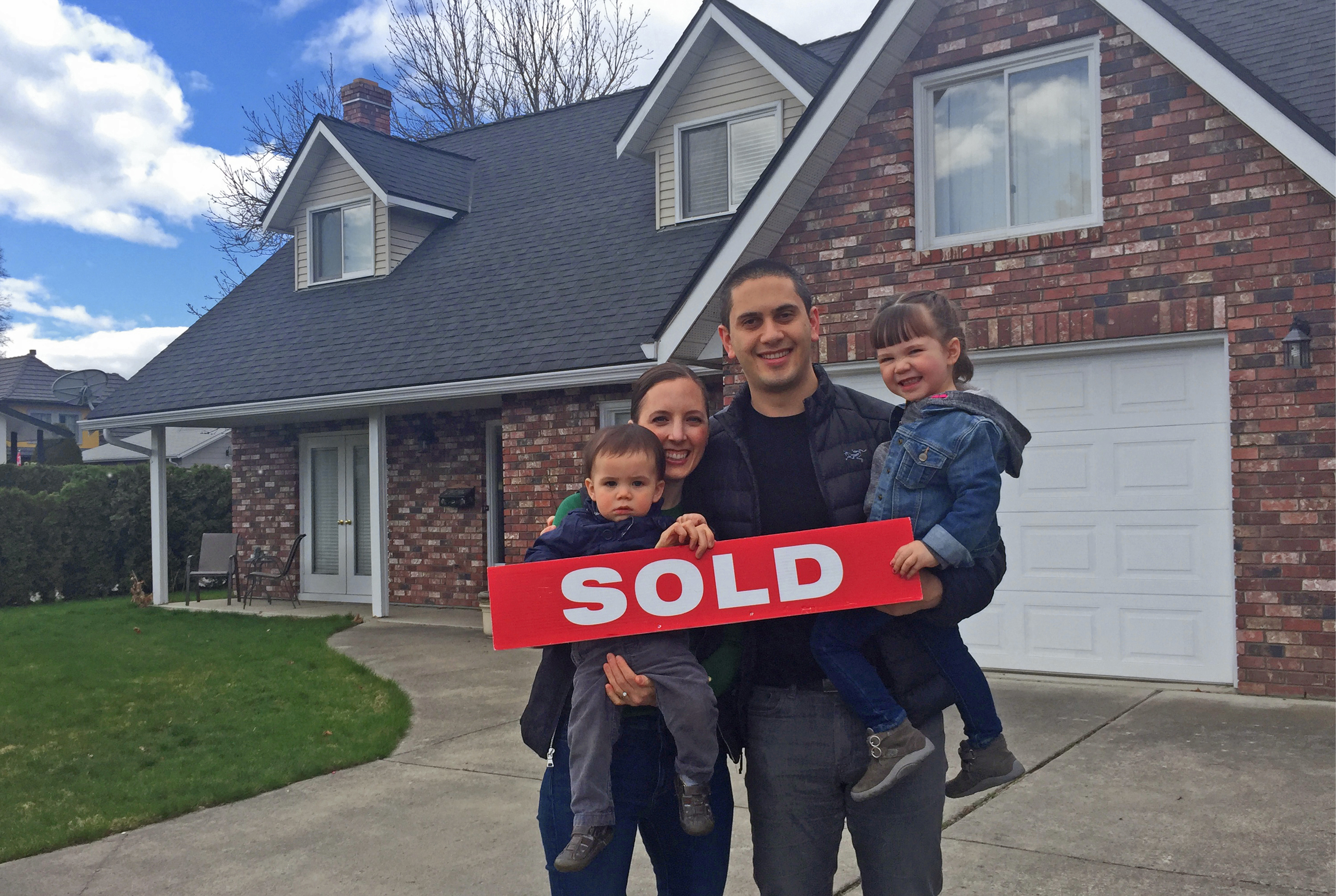 Colleen, Shane and their kids celebrating the purchase of their forever home.