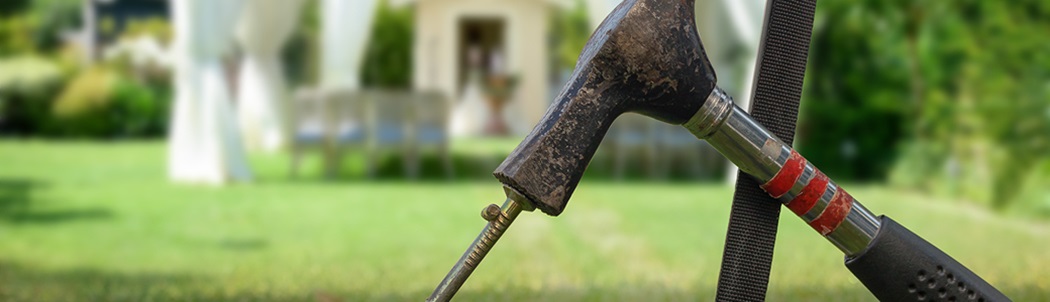 stake being driven into backyard