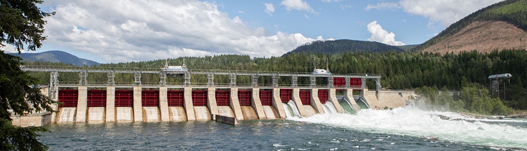 Water rushing through the open spill gates of FortisBC’s Hydroelectric Dam along the Kootenay River