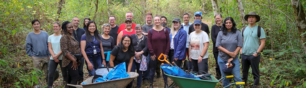 A group of FortisBC employees gather for a shoreline and trail clean up