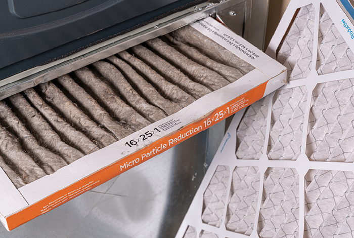 Two furnace filters shown together. One is used and dirty, while the other is clean and new.