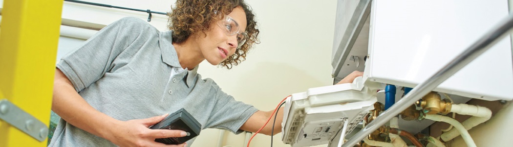 contractor inspecting a gas furnace