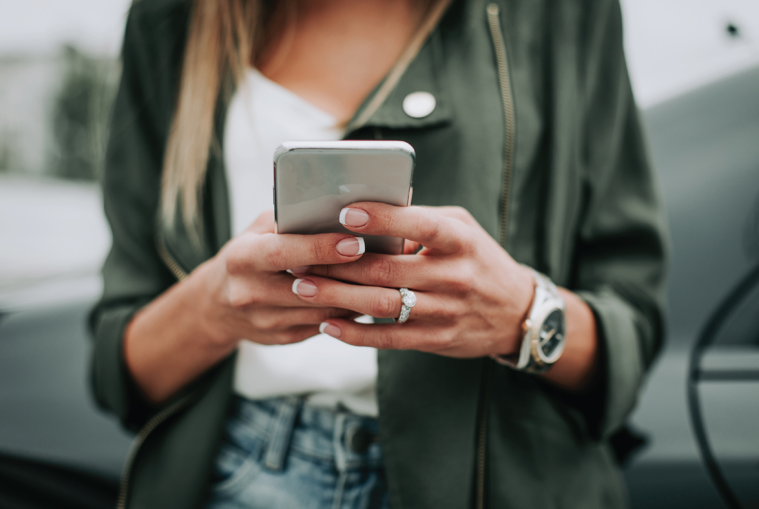 A woman looking at her smart phone.