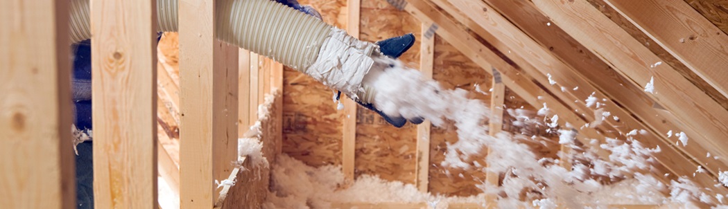 Insulation being blown into an attic
