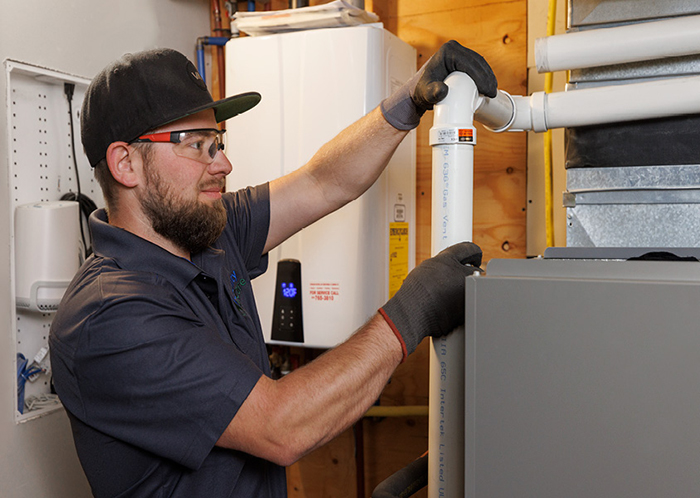 A contractor servicing a furnace.