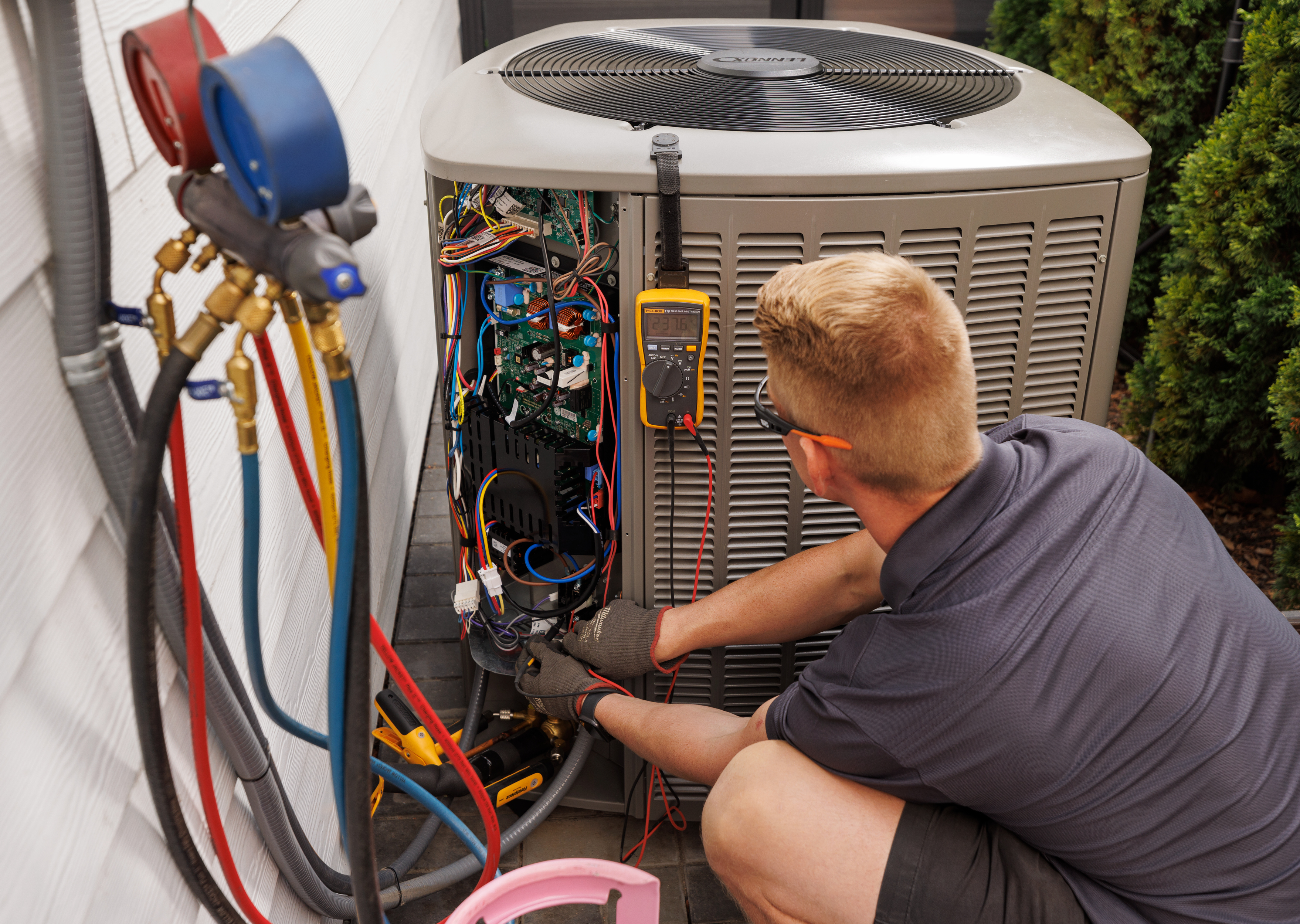 An HVAC contractor servicing a heat pump