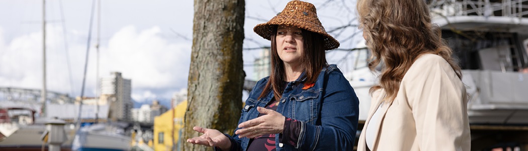 Shannon Henderson, chief operating officer of the Orange Shirt Society, Sḵwx̱wú7mesh Úxwumixw (Squamish Nation) sharing her story of the sixties scoop to Tanya Laing Gahr (right), manager, community & Indigenous initiatives.
