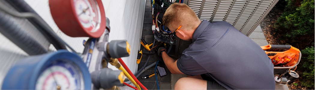 contractor inspecting a gas furnace)