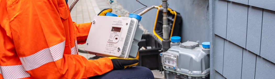 close-up of a wireless advanced gas meter in gas meter technician’s hands