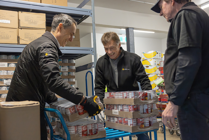 FortisBC volunteers help load stock at a food bank.