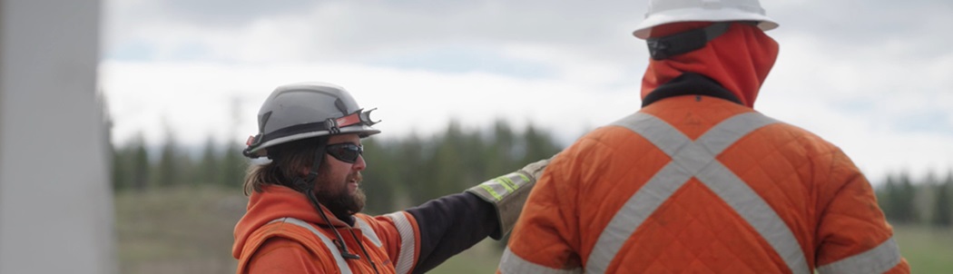 Two FortisBC employees working together on wildfire mitigation