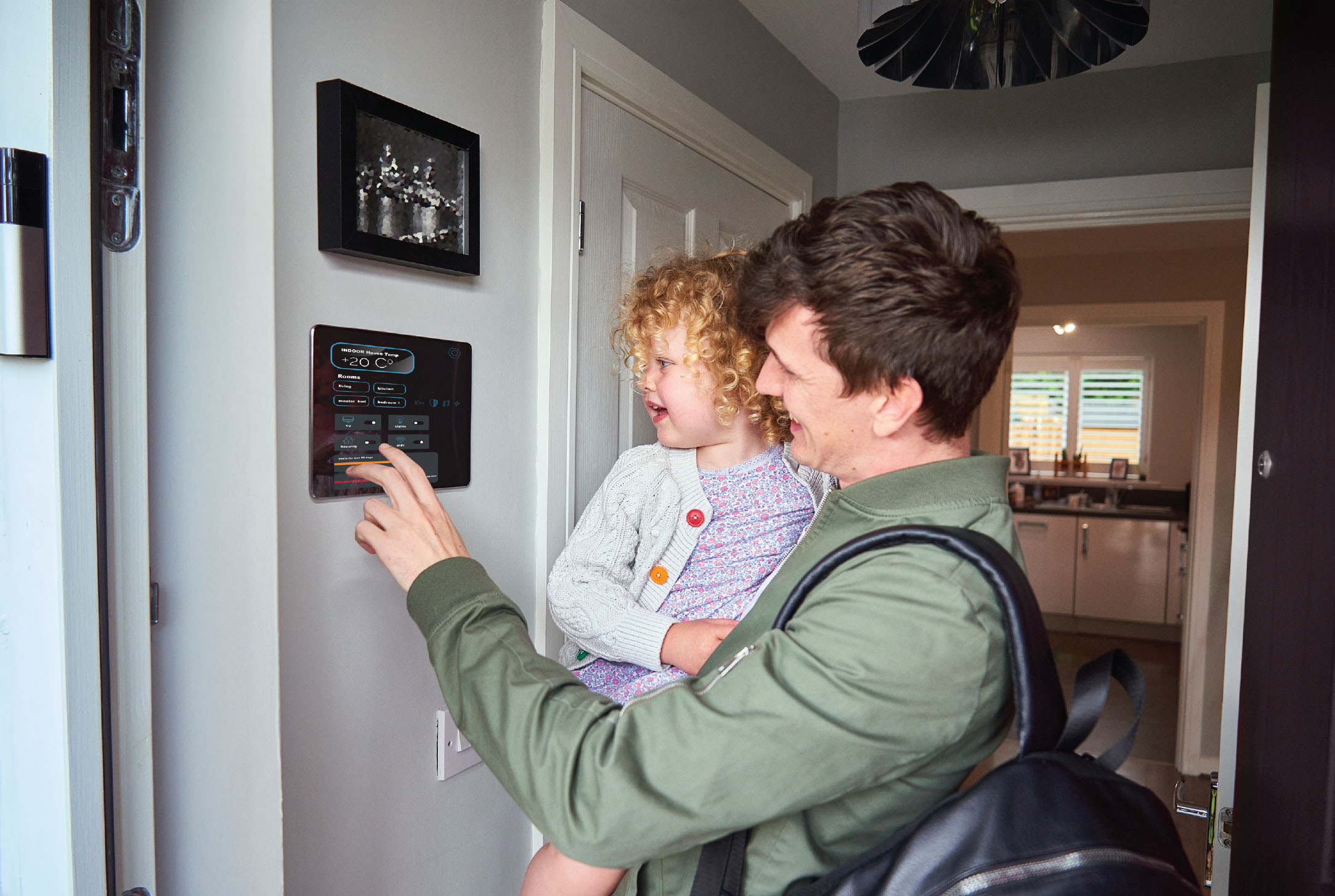 26-035-5-emergprep-7-inline-4 A father programming a connected thermostat to keep his home comfortable during a heat wave.
