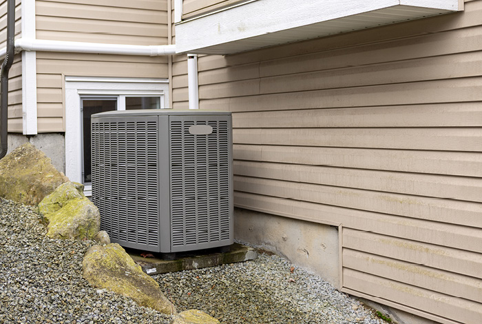 In hot weather, heat pump systems such as this outdoor unit cool a whole home by absorbing warmth from the air inside a home and transferring it outside.