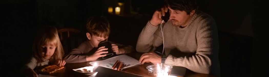 A man with two children in a power outage.