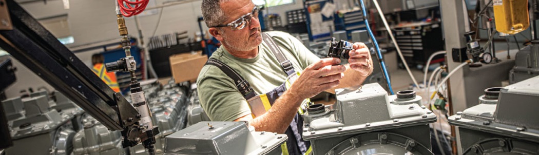 A man working on machinery in a workshop.
