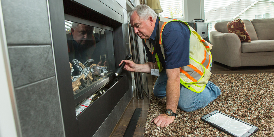 A licensed gas contractor servicing a gas fireplace.