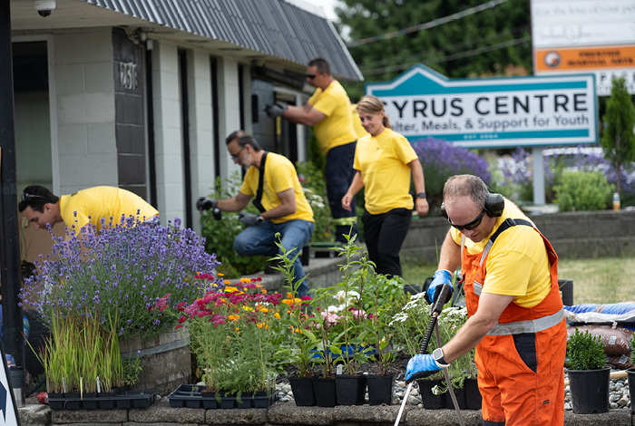 Alfredo Cardenas, Siraz Dalmir, Kim Halowski, and Ken Howsam finish pressure washing and landscaping to help improve safety at Cyrus Centre