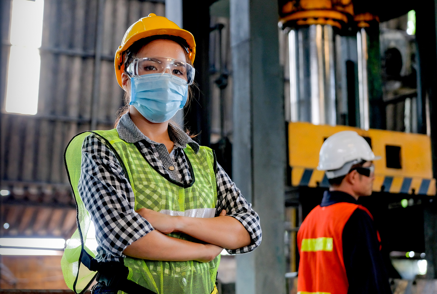 Worker standing with arms crossed