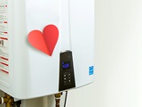 Water heater with a paper heart attached.