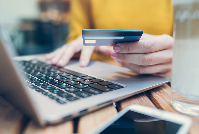 A person shopping online with a credit card
