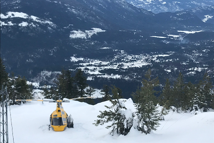 Crews, loaded with heavy gear, snowshoe from helicopter drop points to damaged areas.