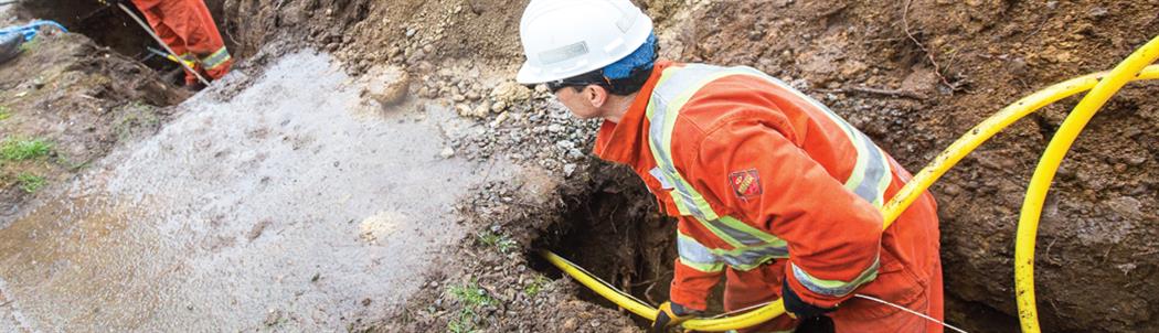 Man installing natural gas pipeline