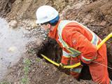 Man installing natural gas pipeline