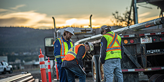 Workers beside a truck.