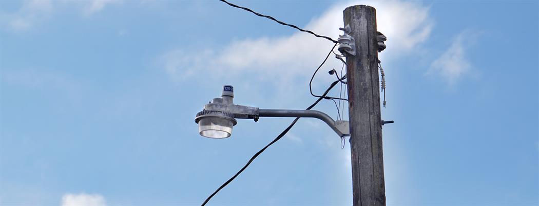 A close up of a yard light against a blue sky (18-150.4)