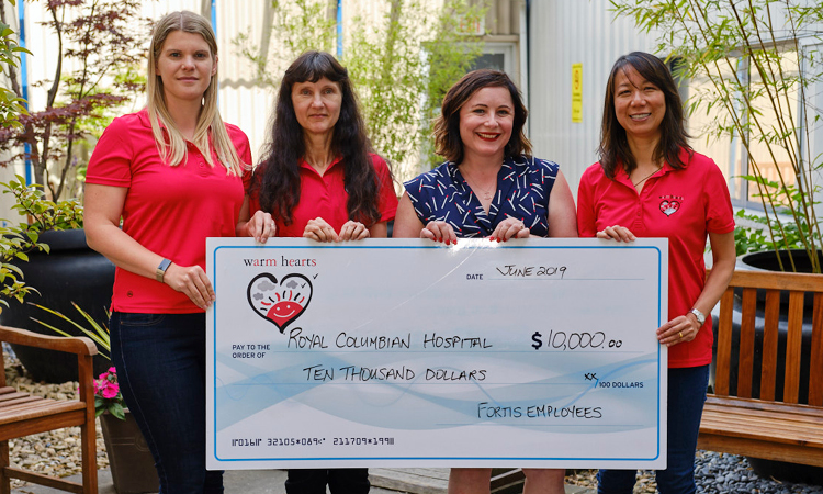 Three members of the Warm Hearts Foundation, Tanja Percival, vice chair (left), Lorel Cop, treasurer (middle left) and Pauline Hum, secretary (right), stand with Catherine Cornish