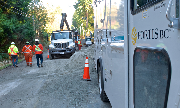 FortisBC truck with workers in the background